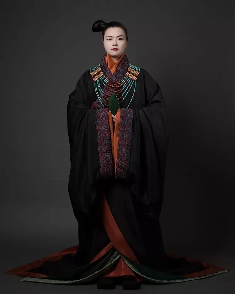 中国🇨🇳秦朝汉服
图文来源：【装束复原】秦贵族女性装束，头梳歪髻，身着黑色直裾袍服，系刺绣宽腰带、以金带钩固定，手持玉圭。
 秦文化以黑色为尊，贵族服饰也崇尚黑色，秦咸阳宫遗址壁画多有表现。
 其所佩戴的炸珠嵌宝金牌饰、红玛瑙碟型珠项饰，复原自马家塬出土实物，该项饰的搭配组合形态来源自更古老的时代，如春秋早期芮国墓葬出土玉饰，腰带复原自秦咸阳宫第一号宫殿遗址出土绢地锁绣绣片，手中所持的玉圭，在战汉时期的墓葬中也多有出土，属于礼器，亦是一种权力的象征。
图1—图3：秦贵族女性装束
图4—图5：秦咸阳宫壁画
图6：秦咸阳宫第一号宫殿遗址出土绢地锁绣绣片
图7：秦始皇陵一号陪葬墓出土明器玉圭
图8：盱眙大云山西汉江都王墓出土玉圭
图9：甘肃马家塬出土项饰
图10：春秋早期芮国墓葬出土项饰
#China#Chinese_style #chinese#中国传统#秦#qin#秦朝#傳統文化#中華風#漢服#漢服日常  #汉服#汉服挑战#汉服摄影 #ChineseCostume #漢服チャレンジ#Chinese_style #中国风#中国#ChineseCostume#chinesefashion #ChineseCulture #ChinaStory#Chinese_culture #hanfu_challenge #hanfu#lgbtq #summer #hydrangeafashion  #outfitoftheday  #hanfugirl #hanfuboy